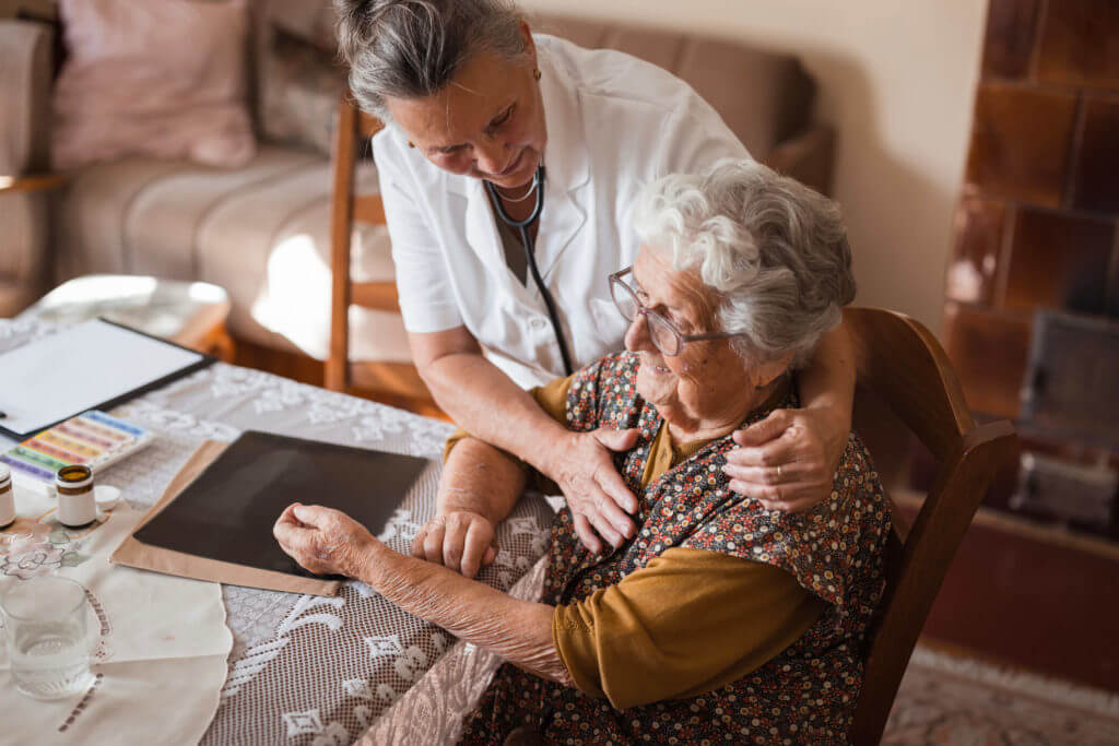 senior caregiver assisting woman 